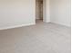 Carpeted bedroom boasts neutral walls, base trim, and an open doorway, awaiting personalization and decor at 5335 Wolf Creek Dr, Apollo Beach, FL 33572