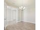 An open dining room with tile flooring and an elegant chandelier at 5335 Wolf Creek Dr, Apollo Beach, FL 33572