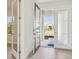 Inviting foyer showcasing a glass-paneled front door and light tile flooring at 5335 Wolf Creek Dr, Apollo Beach, FL 33572