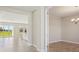 Open concept layout with tile floors, connecting the kitchen and dining area, bathed in natural light at 5335 Wolf Creek Dr, Apollo Beach, FL 33572