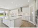 This spacious kitchen features white cabinets, a large island, and modern stainless steel appliances at 5335 Wolf Creek Dr, Apollo Beach, FL 33572