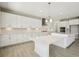 Bright modern kitchen with white cabinets, subway tile backsplash, and expansive island at 5335 Wolf Creek Dr, Apollo Beach, FL 33572