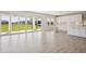 Spacious living room leading to a modern kitchen and outdoor area through sliding doors at 5335 Wolf Creek Dr, Apollo Beach, FL 33572