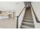 Carpeted staircase with dark wood railings at 5335 Wolf Creek Dr, Apollo Beach, FL 33572
