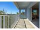 Bright balcony featuring wood floors, a white railing, and views of the boats docked nearby at 545 Pinellas Bayway S # 109, St Petersburg, FL 33715