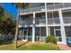 Multi-story condo featuring screened patios, balconies, and a well-maintained lawn at 545 Pinellas Bayway S # 109, St Petersburg, FL 33715