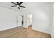 Clean bedroom featuring hardwood flooring and an ensuite bathroom at 6314 Soratrace St, Lithia, FL 33547