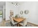 Bright dining room featuring modern chandelier, statement mirrors and a wooden table for stylish Gathering dinners at 6314 Soratrace St, Lithia, FL 33547