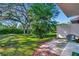 Lush, green backyard with mature trees providing shade and privacy at 6843 Se Dartmouth Hill St, Riverview, FL 33578