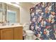 The bathroom features a floral shower curtain and a wooden vanity at 6843 Se Dartmouth Hill St, Riverview, FL 33578