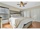 Bright bedroom with hardwood floors, ceiling fan, and large headboard at 6843 Se Dartmouth Hill St, Riverview, FL 33578