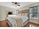 Bright bedroom with hardwood floors, ceiling fan, and large headboard at 6843 Se Dartmouth Hill St, Riverview, FL 33578