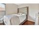 This bedroom features hardwood floors, and a tall headboard, creating a cozy and inviting space at 6843 Se Dartmouth Hill St, Riverview, FL 33578