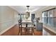 Well-lit dining area with hardwood floors, a workspace, and neutral decor for versatile use at 6843 Se Dartmouth Hill St, Riverview, FL 33578