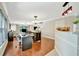 Open-concept space with hardwood floors, dining area, workspace, and natural light from large windows at 6843 Se Dartmouth Hill St, Riverview, FL 33578