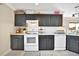 Well-lit kitchen features white appliances, dark cabinets, and lots of storage space at 6843 Se Dartmouth Hill St, Riverview, FL 33578