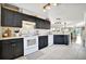 Well-lit kitchen features white appliances, dark cabinets, and lots of storage space at 6843 Se Dartmouth Hill St, Riverview, FL 33578