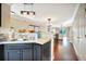 Open-concept kitchen with breakfast bar, seamlessly flowing into the adjacent dining area at 6843 Se Dartmouth Hill St, Riverview, FL 33578