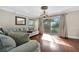 Inviting living room featuring hardwood floors, natural light, and comfortable seating arrangements at 6843 Se Dartmouth Hill St, Riverview, FL 33578