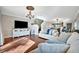 Bright living room featuring hardwood floors, neutral decor, and a staircase leading to the upper level at 6843 Se Dartmouth Hill St, Riverview, FL 33578