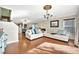 Open-concept living room featuring hardwood floors, neutral decor, and access to adjacent dining area at 6843 Se Dartmouth Hill St, Riverview, FL 33578