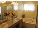 Relaxing bathroom featuring dual sinks, a soaking tub, and a separate shower at 716 Burlwood St, Brandon, FL 33511