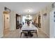 Elegant dining room with chandelier, tile floors, and views into kitchen and living areas at 716 Burlwood St, Brandon, FL 33511