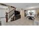 Open-concept living and dining area with tile flooring, a staircase, fireplace, and large windows at 716 Burlwood St, Brandon, FL 33511