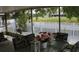 Enclosed patio with furniture, perfect for enjoying the lake view and outdoor grilling at 716 Burlwood St, Brandon, FL 33511