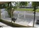 Secluded outdoor patio with a grill, bird feeder, and tranquil water views at 716 Burlwood St, Brandon, FL 33511