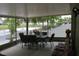 Enclosed patio overlooking a lake, with a table and seating for enjoying the tranquil surroundings at 716 Burlwood St, Brandon, FL 33511