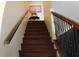 A wooden staircase with metal and wood railing leads to the upper level at 716 Burlwood St, Brandon, FL 33511