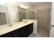 Contemporary bathroom featuring dual sinks, quartz countertops, and a frameless glass shower at 740 Steel Dr, Apollo Beach, FL 33572