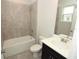 Bright bathroom featuring vanity, tub, tile surround and neutral color palette at 740 Steel Dr, Apollo Beach, FL 33572