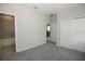 Carpeted bedroom featuring a double door closet and ensuite bathroom with shower and tub at 740 Steel Dr, Apollo Beach, FL 33572