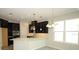 Modern kitchen featuring stainless appliances, breakfast bar, black cabinetry, and recessed lighting at 740 Steel Dr, Apollo Beach, FL 33572