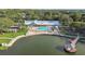 Stunning aerial perspective of the community clubhouse featuring a pool and lakeside gazebo, surrounded by lush greenery at 8130 Braddock Cir # 3, Port Richey, FL 34668