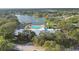 Scenic aerial view featuring a community clubhouse with a pool, gazebo, and a tranquil lake with fountain at 8130 Braddock Cir # 3, Port Richey, FL 34668