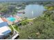 Picturesque aerial shot showcasing a community pool, lake with gazebo and fountain, surrounded by green landscape at 8130 Braddock Cir # 3, Port Richey, FL 34668