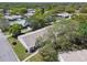 A top-down perspective shows houses with lush, mature trees and vibrant lawns at 8130 Braddock Cir # 3, Port Richey, FL 34668