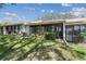 View of the backyard and exterior of the home and enclosed patio at 8130 Braddock Cir # 3, Port Richey, FL 34668