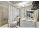 Bathroom features a vanity with sink, a tub with shower, and a toilet at 8130 Braddock Cir # 3, Port Richey, FL 34668