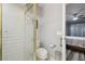 Bathroom featuring a toilet and glass shower, and a view into the bedroom at 8130 Braddock Cir # 3, Port Richey, FL 34668
