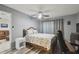 Cozy bedroom features a ceiling fan, neutral walls, and a comfortable-looking bed at 8130 Braddock Cir # 3, Port Richey, FL 34668