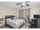 Comfortable bedroom with ceiling fan and gray wood-look floors at 8130 Braddock Cir # 3, Port Richey, FL 34668