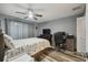 Comfortable bedroom featuring wood floors, ceiling fan, and an inviting atmosphere at 8130 Braddock Cir # 3, Port Richey, FL 34668