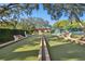 Well-maintained community bocce ball court surrounded by benches and lush greenery at 8130 Braddock Cir # 3, Port Richey, FL 34668