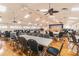 Large community hall with tables, chairs, a stage, and hardwood floors at 8130 Braddock Cir # 3, Port Richey, FL 34668