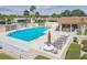 Community pool with chairs, umbrellas, a covered picnic area and tables at 8130 Braddock Cir # 3, Port Richey, FL 34668