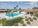 Community pool and patio area with picnic tables, shade and lounge chairs at 8130 Braddock Cir # 3, Port Richey, FL 34668